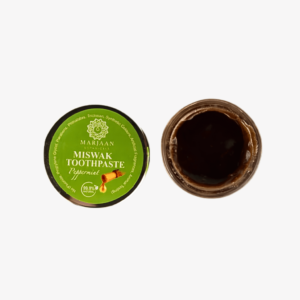 Miswak toothpaste with bamboo toothbrush and fresh mint leaves